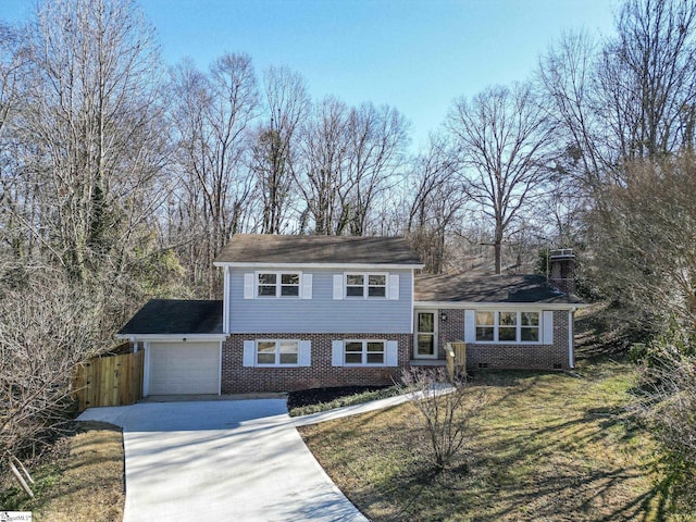 view of front of home with a garage and a front lawn