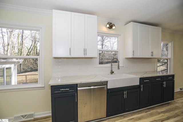 kitchen featuring dishwasher, light hardwood / wood-style floors, sink, white cabinets, and light stone counters