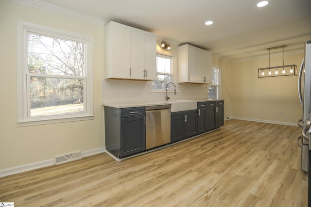 kitchen with backsplash, dishwasher, white cabinetry, hanging light fixtures, and light wood-type flooring