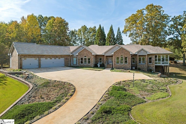 single story home with a garage and a front lawn