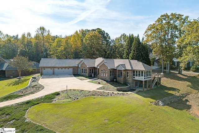 ranch-style house featuring a front lawn and a garage