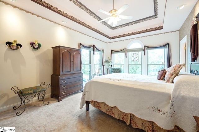 bedroom with ceiling fan, carpet, access to exterior, a raised ceiling, and crown molding