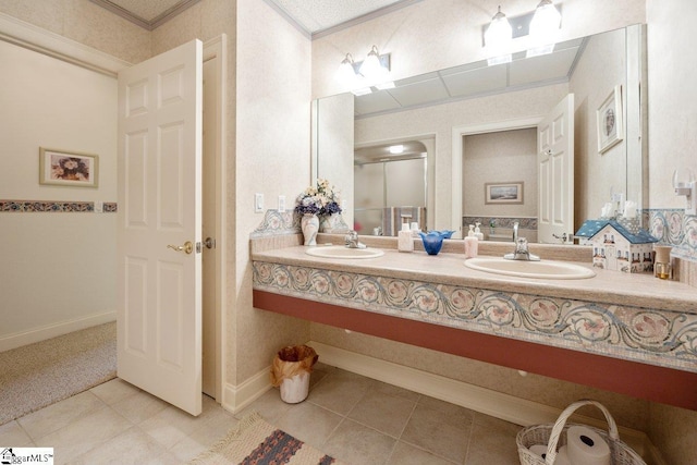 bathroom with tile patterned flooring, crown molding, and vanity