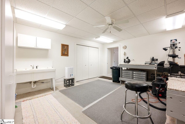 misc room featuring ceiling fan, a drop ceiling, and sink