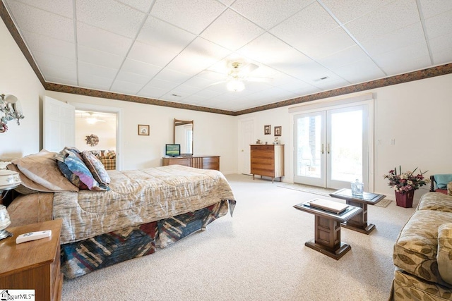 carpeted bedroom with access to outside, a paneled ceiling, french doors, and ceiling fan