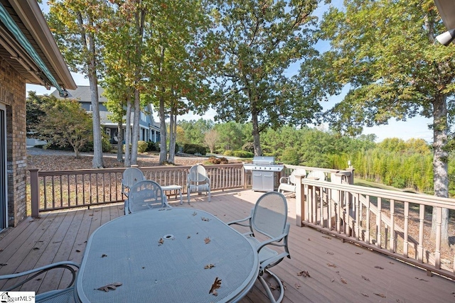 wooden deck featuring a grill