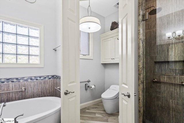 bathroom with toilet, wood-type flooring, and shower with separate bathtub