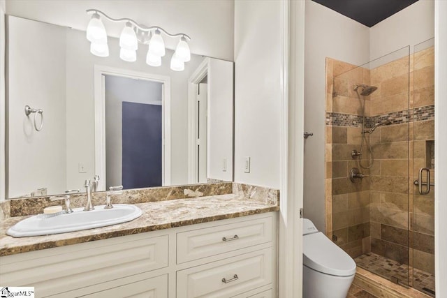 bathroom with vanity, toilet, and a shower with door