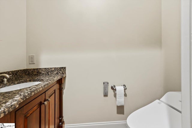 bathroom featuring toilet and vanity