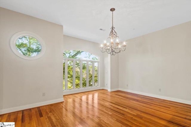 interior space featuring an inviting chandelier and hardwood / wood-style flooring