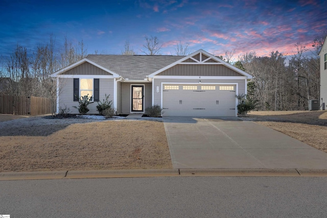 view of front of home featuring central air condition unit and a garage