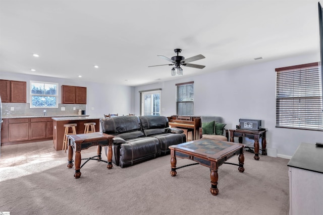 living room with light carpet and ceiling fan