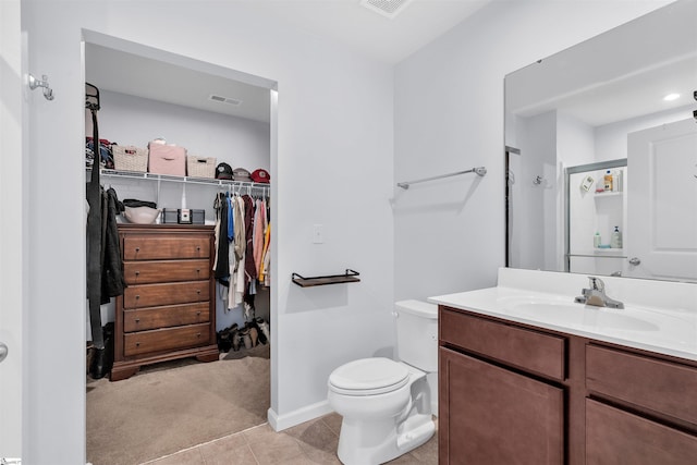 bathroom featuring an enclosed shower, vanity, and toilet