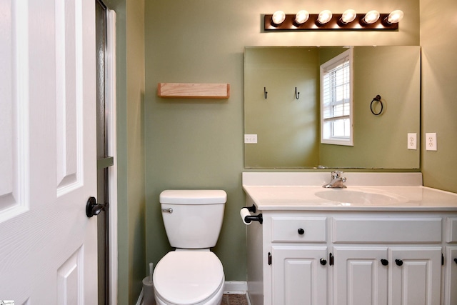 bathroom with toilet and vanity