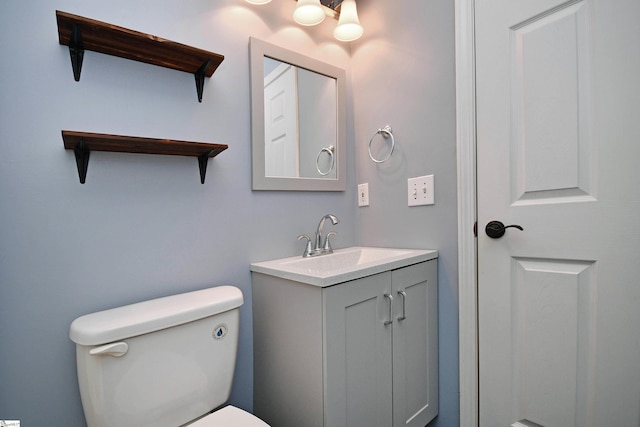 bathroom featuring toilet and vanity