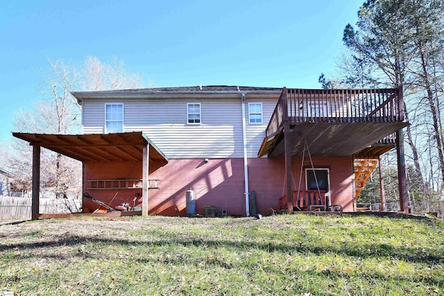 rear view of property with a deck and a lawn