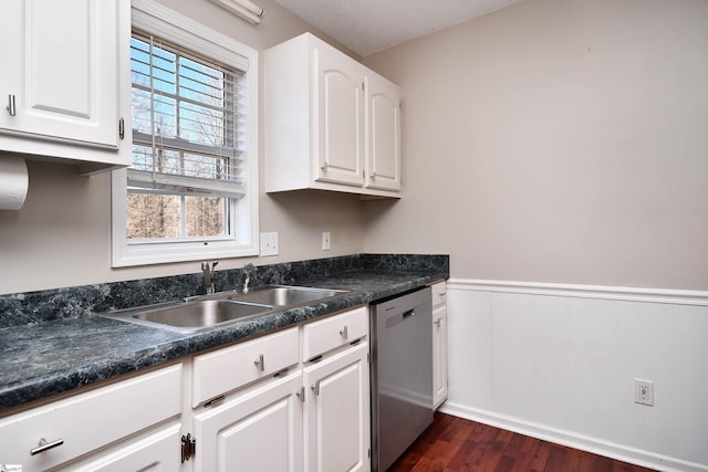 kitchen with dark hardwood / wood-style floors, stainless steel dishwasher, white cabinets, and sink