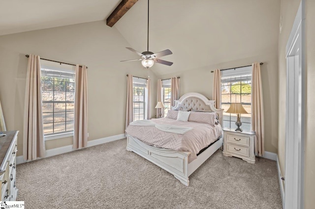 bedroom with ceiling fan, light colored carpet, multiple windows, and beam ceiling