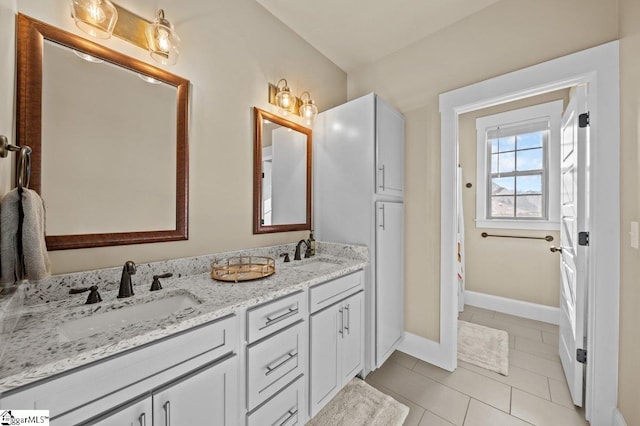 bathroom featuring tile patterned flooring and vanity