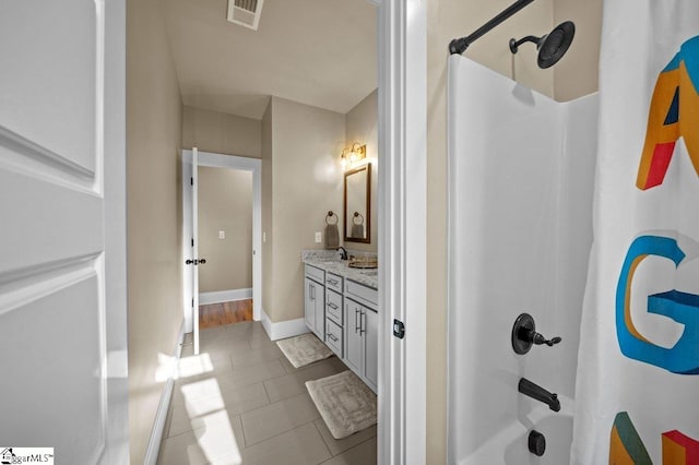 bathroom with vanity, tile patterned floors, and shower / bath combo with shower curtain