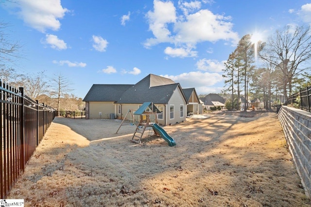 back of property featuring a playground