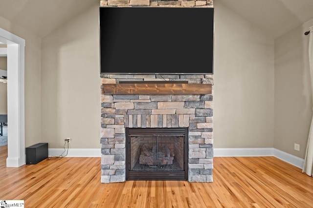 interior details featuring a fireplace and wood-type flooring