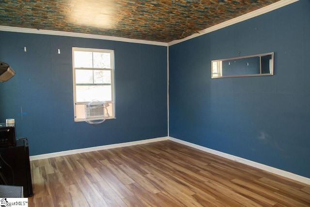 unfurnished room with brick ceiling, ornamental molding, cooling unit, and hardwood / wood-style floors