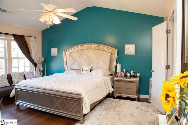 bedroom featuring ceiling fan, wood-type flooring, and vaulted ceiling