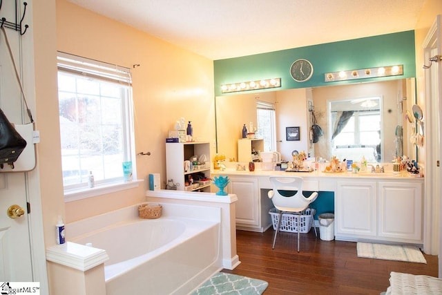 bathroom with vanity, shower with separate bathtub, and hardwood / wood-style floors