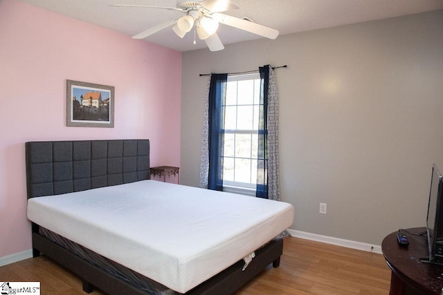 bedroom featuring ceiling fan and light hardwood / wood-style floors