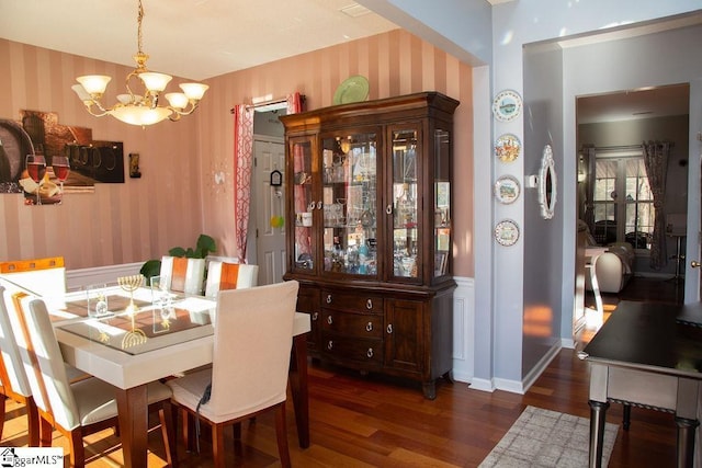 dining space featuring an inviting chandelier and dark hardwood / wood-style flooring