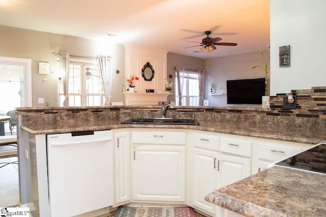 kitchen with ceiling fan, dishwasher, kitchen peninsula, sink, and white cabinets