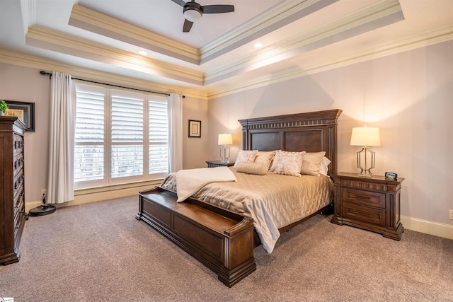 bedroom with light carpet, ceiling fan, ornamental molding, and a tray ceiling