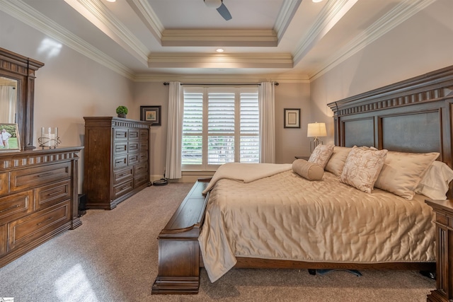 bedroom with ceiling fan, crown molding, light colored carpet, and a raised ceiling