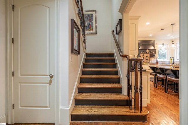 staircase featuring wood-type flooring