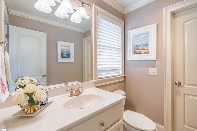 bathroom with toilet, vanity, and ornamental molding