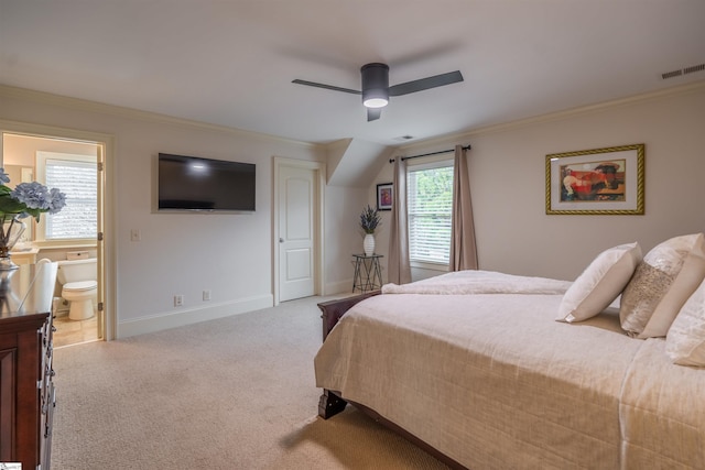 carpeted bedroom featuring ceiling fan, ornamental molding, and ensuite bath