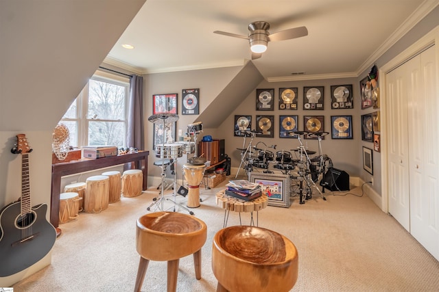 sitting room featuring ceiling fan, ornamental molding, and carpet flooring