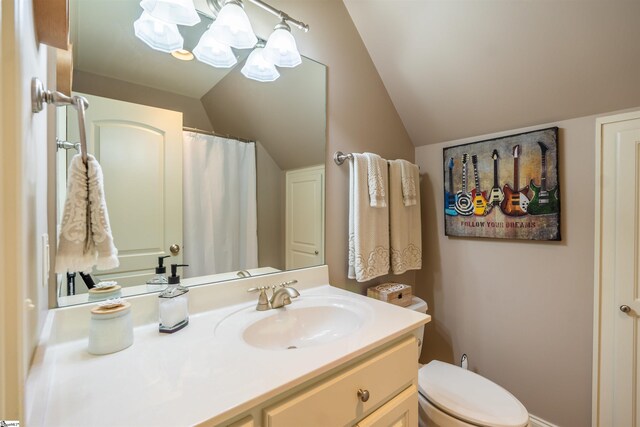 bathroom featuring vaulted ceiling, toilet, and vanity