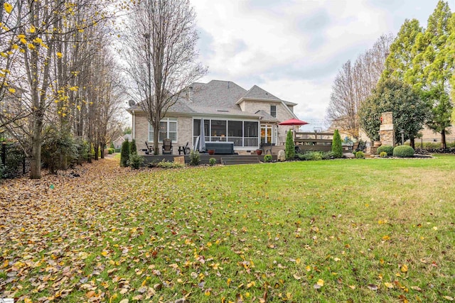 back of house with a sunroom, a yard, and a patio