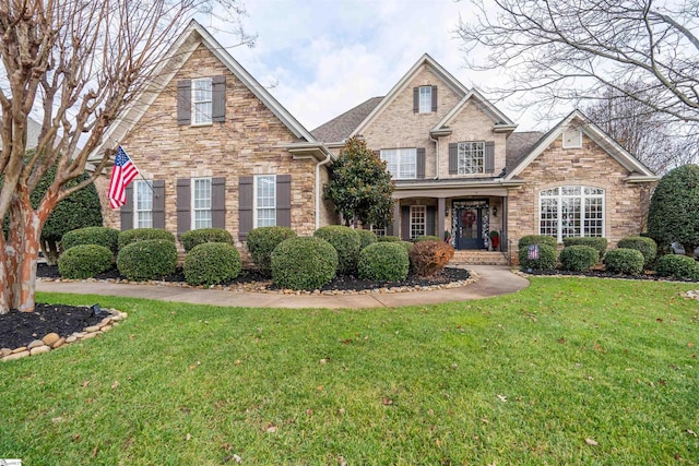 front facade featuring a front lawn and a porch