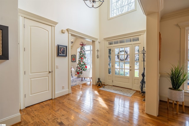 foyer with a chandelier and light wood-type flooring