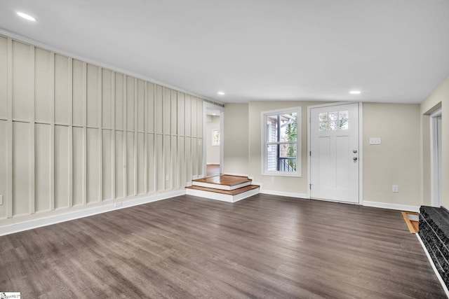 entrance foyer featuring vaulted ceiling and dark hardwood / wood-style flooring