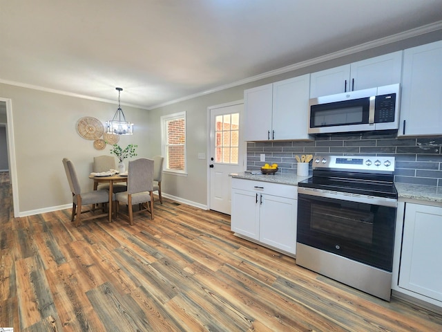 kitchen with hardwood / wood-style flooring, stainless steel appliances, backsplash, a notable chandelier, and white cabinets