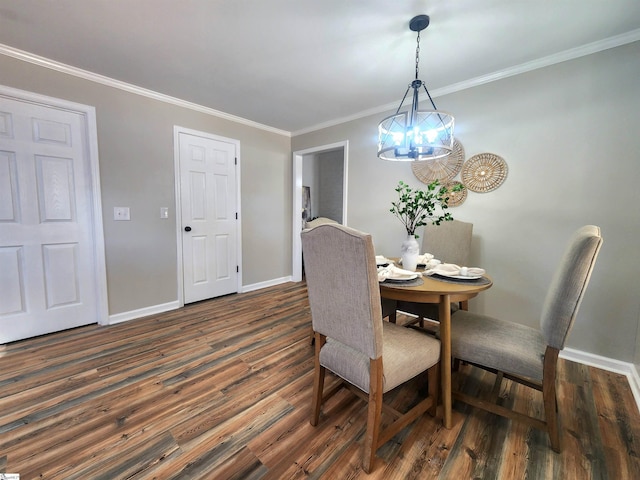 dining room with dark hardwood / wood-style flooring, ornamental molding, and a chandelier