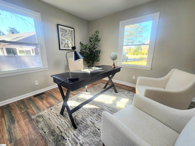 home office with dark hardwood / wood-style flooring