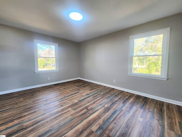 spare room featuring dark hardwood / wood-style flooring