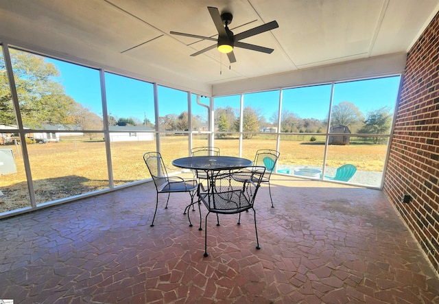 sunroom / solarium with ceiling fan and a healthy amount of sunlight