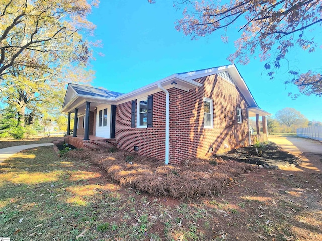 view of side of home with a porch