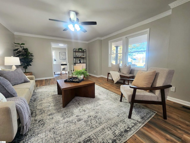 living room with ceiling fan, dark hardwood / wood-style floors, and crown molding